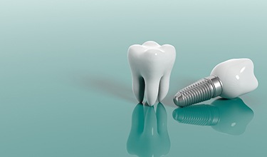 Model of a dental implant lying next to a tooth