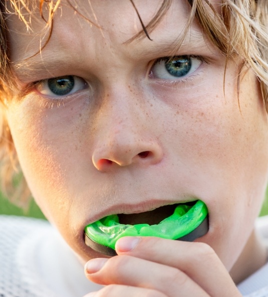 Boy putting in an athletic mouthguard