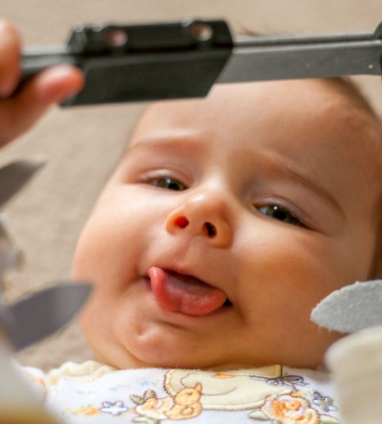 Close up of infant sticking tongue out