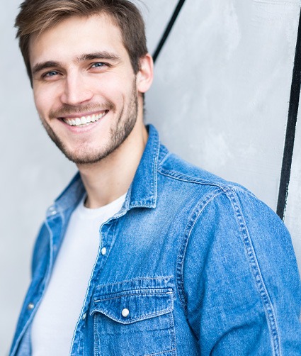 Smiling man wearing a denim jacket