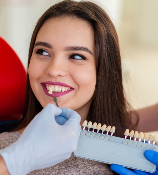 Woman having teeth shade matched by cosmetic dentist in Carrollton