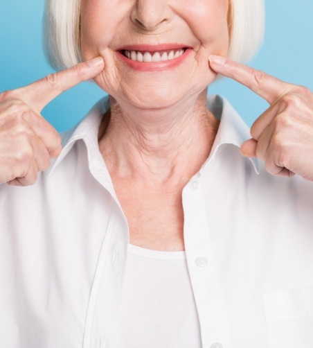 Close up of senior woman pointing to smile