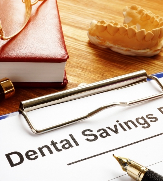 Dental savings plan form on a clipboard