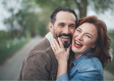 Woman hugging man from side