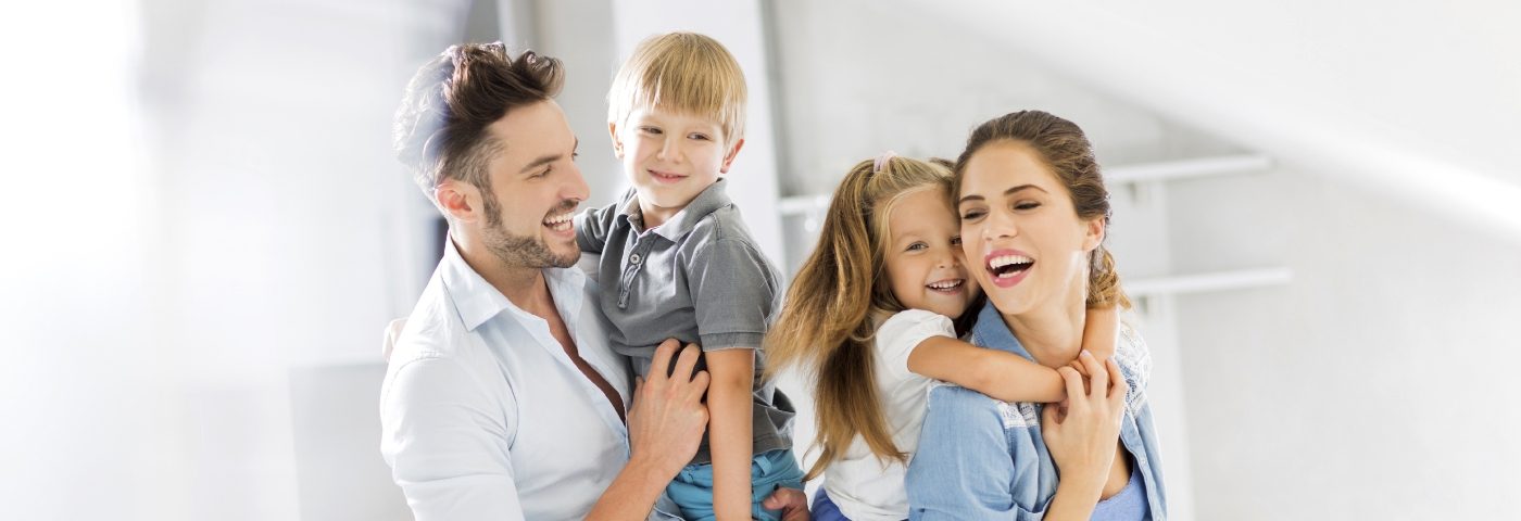 Man and woman carrying children