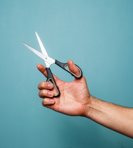 Close up of hands holding scissors