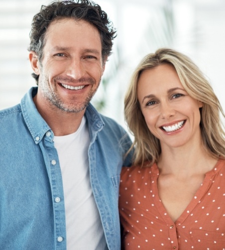 Man and woman standing next to each other and smiling