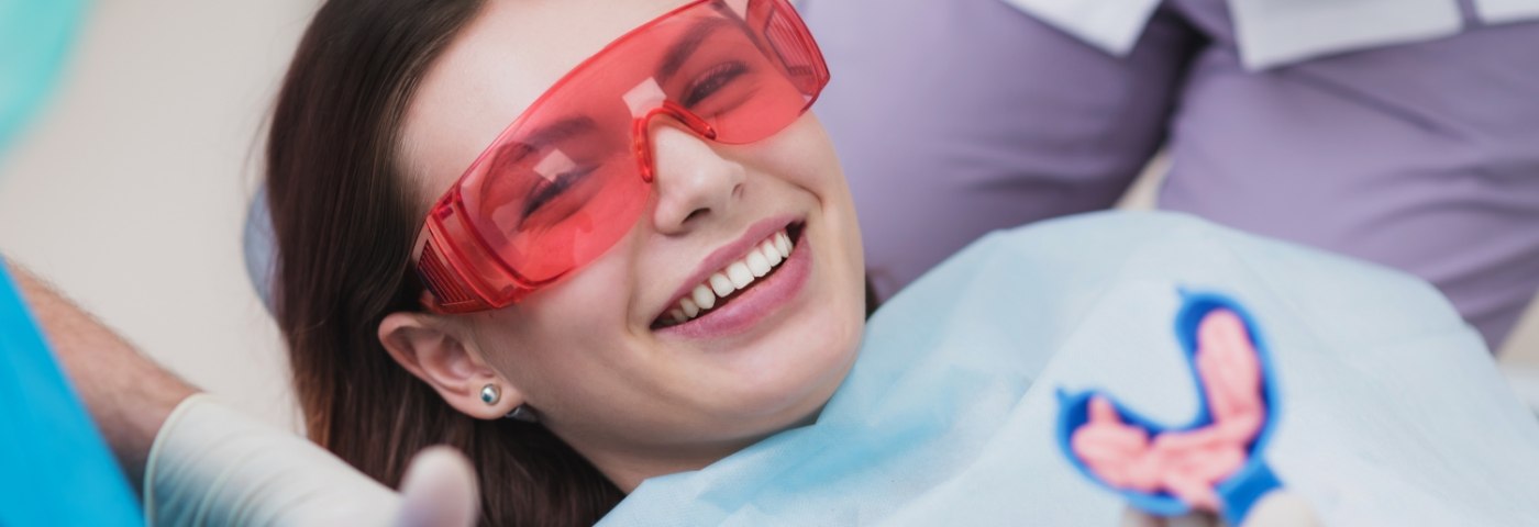 Woman sitting back in dental chair waiting for fluoride treatment in Carrollton