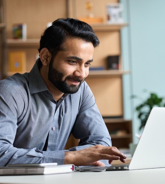 Bearded man using a laptop