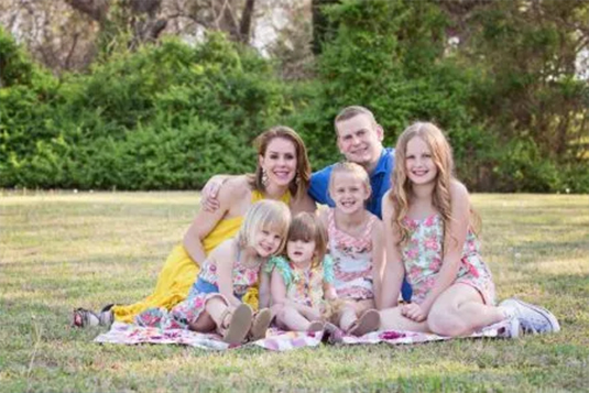 Large family on picnic blanket outside