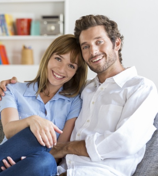 Man and woman sitting together on couch