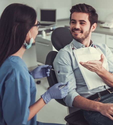 Male patient speaking to female dentist