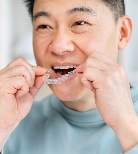 Man putting in Invisalign trays