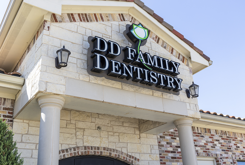 DD Family Dentistry logo and phone number on window