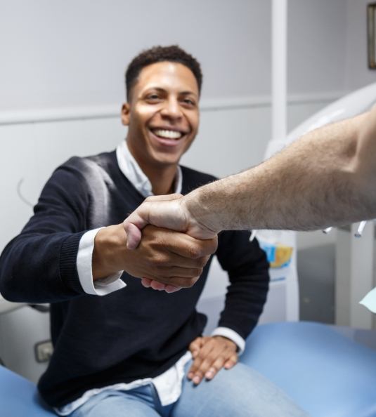 Patient shaking dentists hand after preventive dentistry in Carrollton