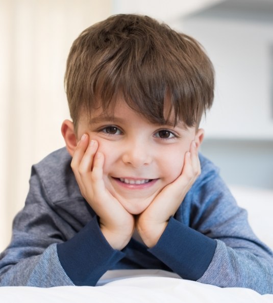 Little boy resting his head on his hands