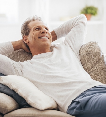 Man leaning back on couch and relaxing