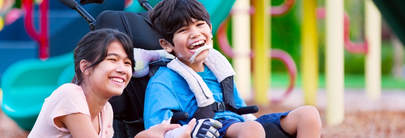 Two children sitting and laughing