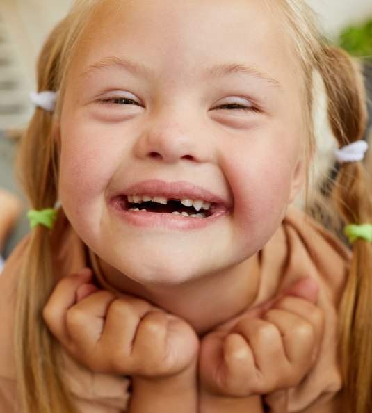 Close up of little girl with missing tooth