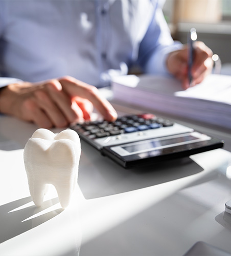 Close up of desk with tooth and calculator