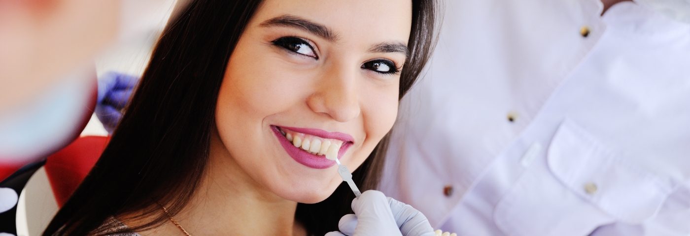 Woman having teeth shade matched for veneers in Carrollton