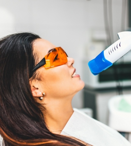 Woman leaning back about to receive teeth whitening