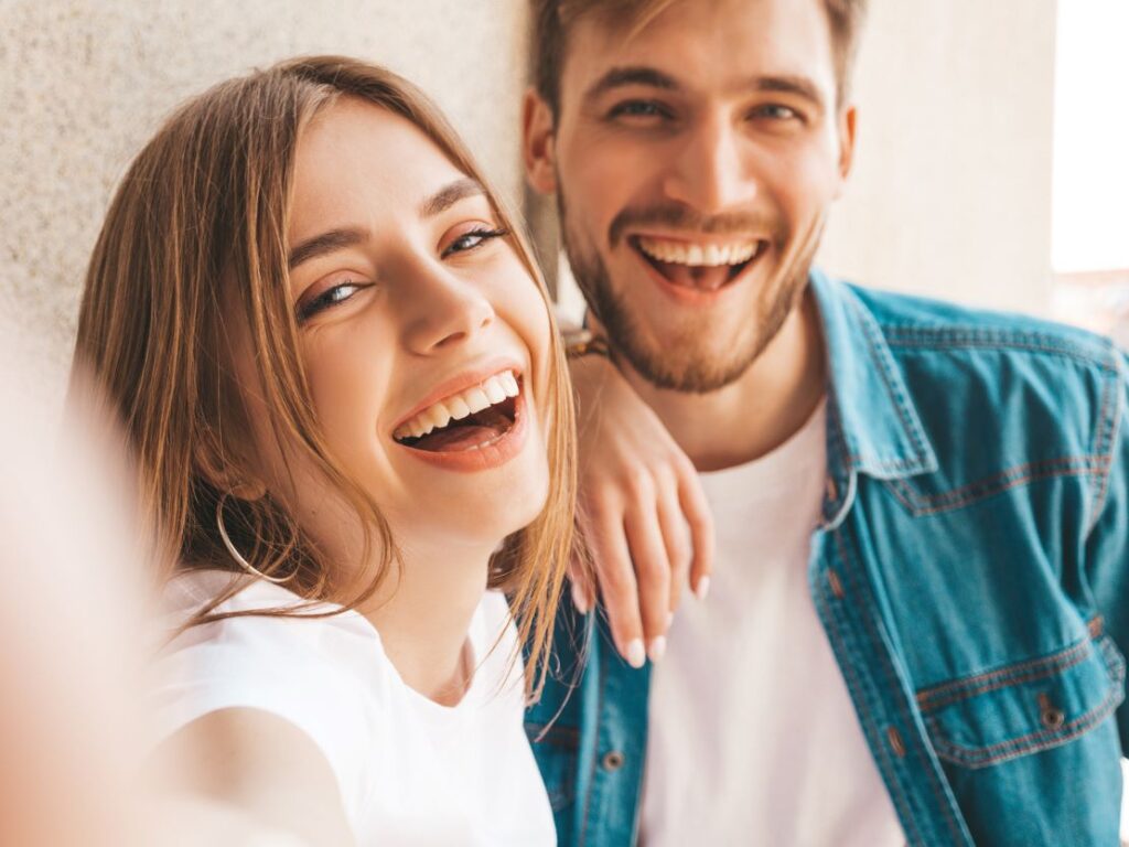 A man and woman smiling.