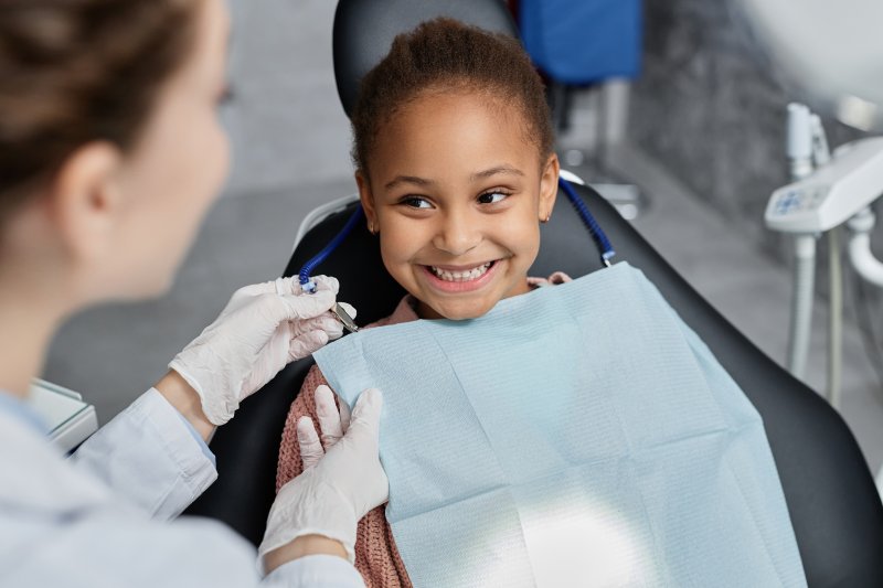 Girl smiles at dentist